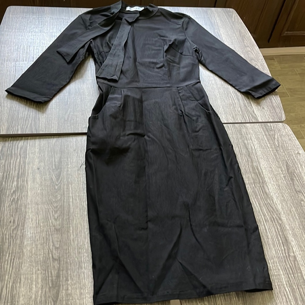 Black form fitting quarter length sleeve dress